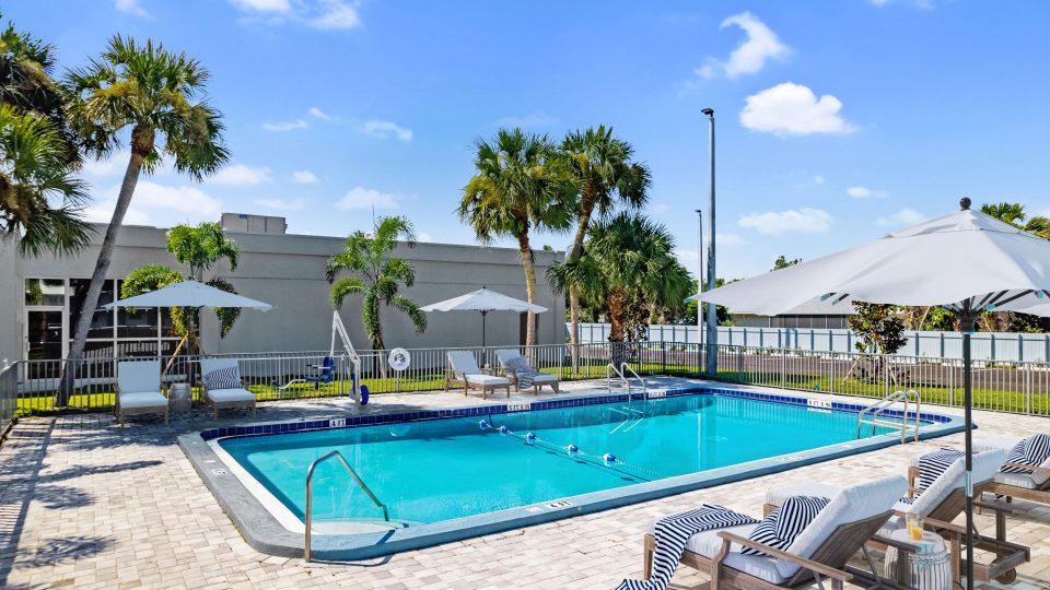 Pool view with chairs and umbrellas